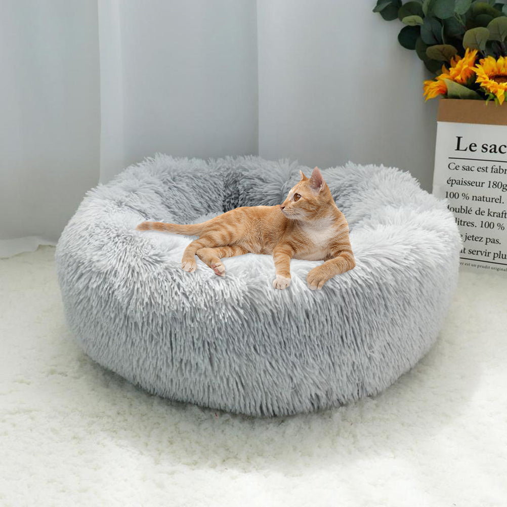 Cat curled up in calming donut pet bed